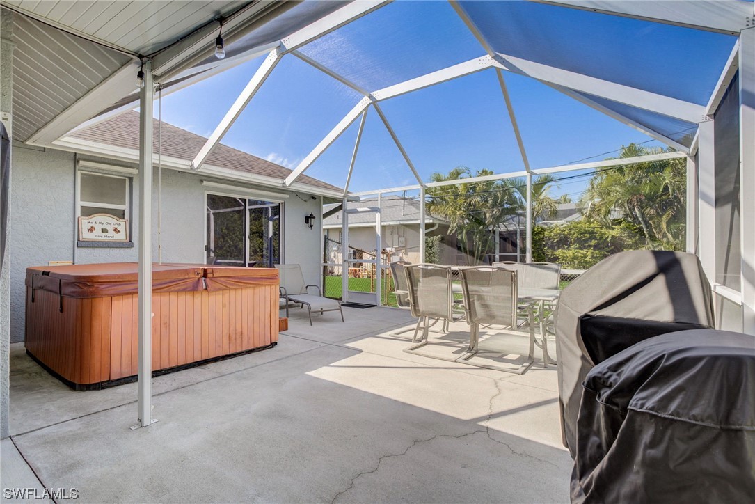 8337 Robin Road Fort Myers, FL 33967 - Photo 26 of 36 a patio with a table and chairs under an umbrella