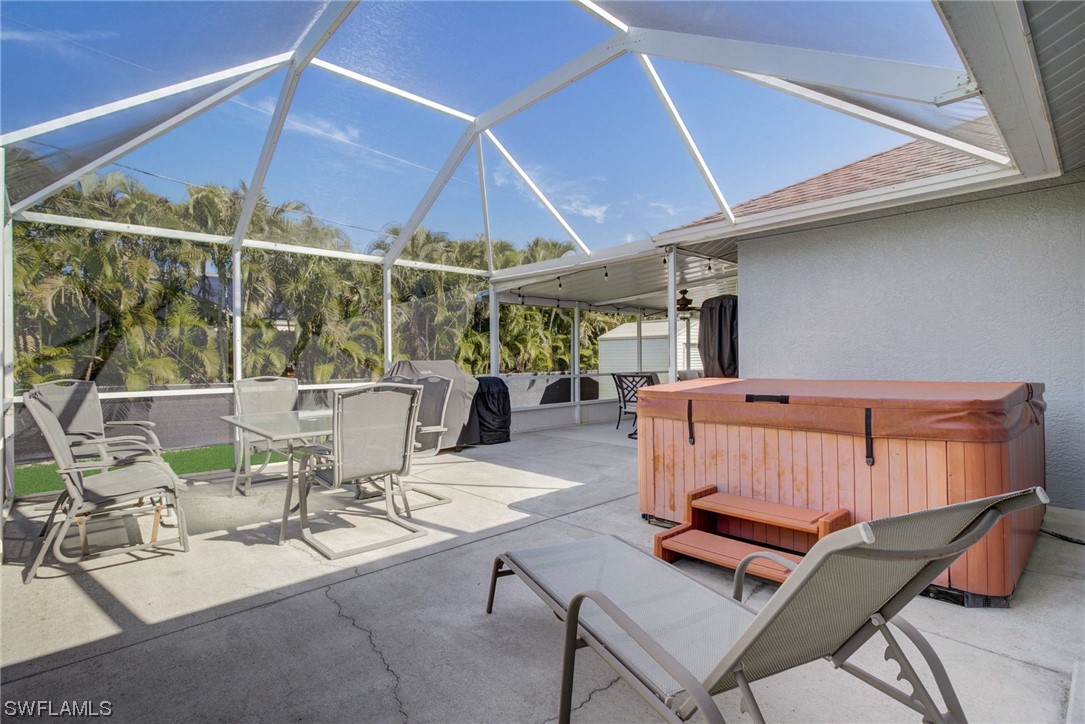 8337 Robin Road Fort Myers, FL 33967 - Photo 27 of 36 a view of a patio with a table and chairs under an umbrella