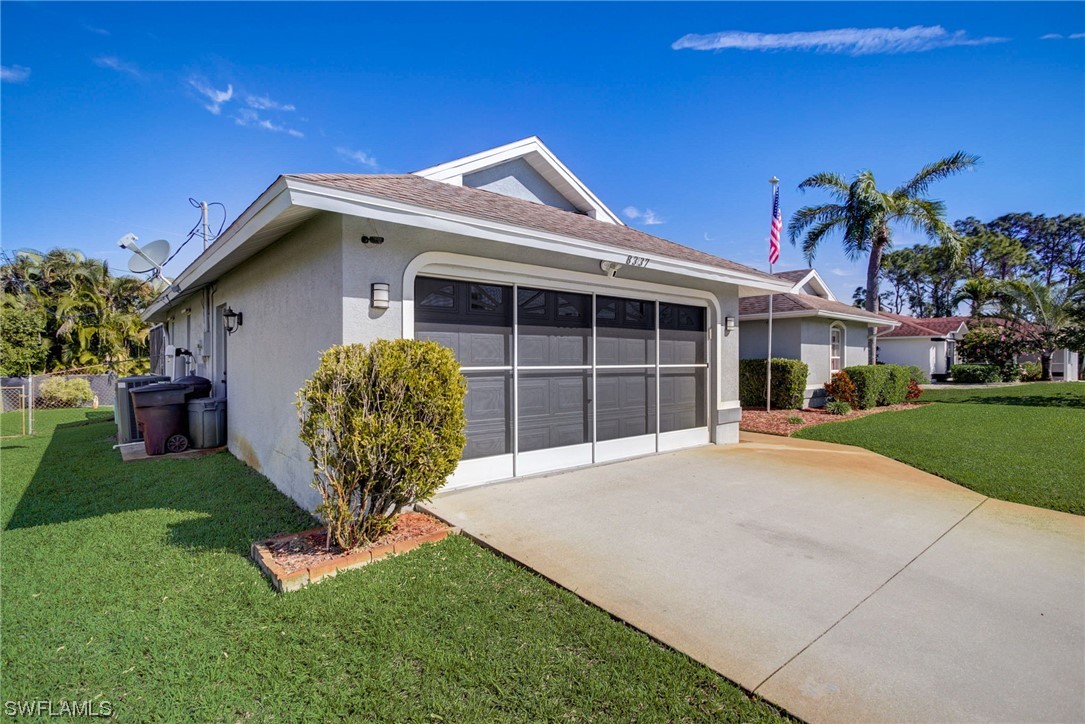 8337 Robin Road Fort Myers, FL 33967 - Photo 34 of 36 a front view of a house with garden