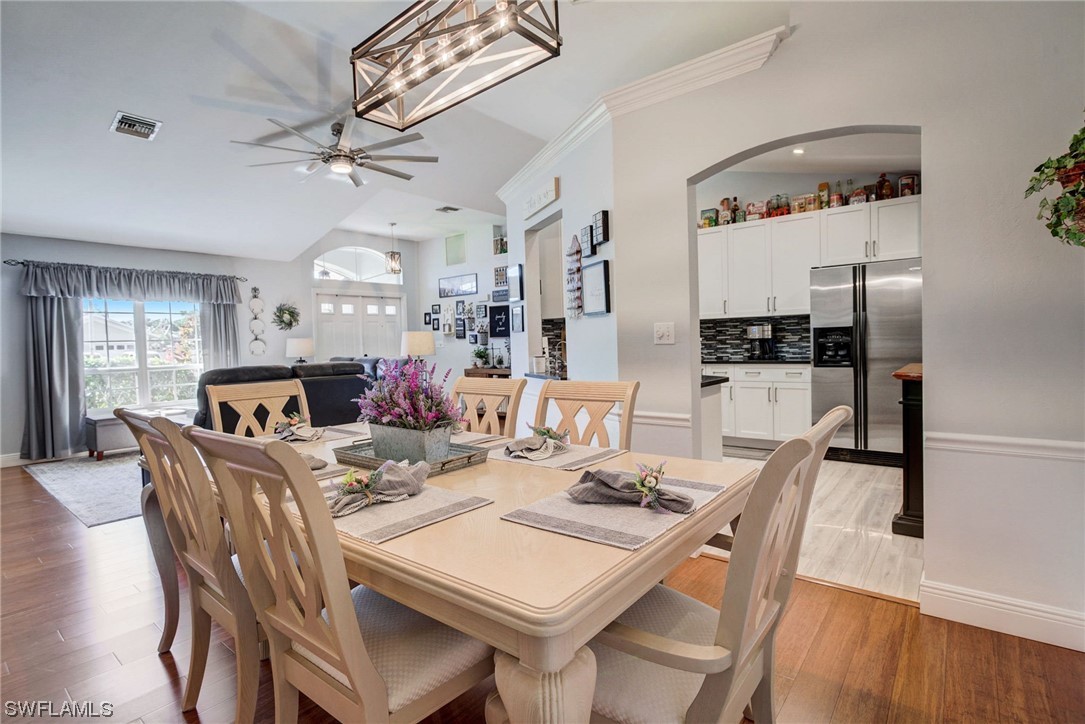 8337 Robin Road Fort Myers, FL 33967 - Photo 9 of 36 a view of a dining room with furniture and wooden floor