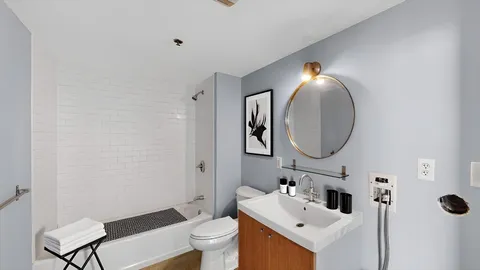 a bathroom with a sink mirror and toilet