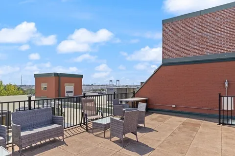a view of a balcony with wooden fence