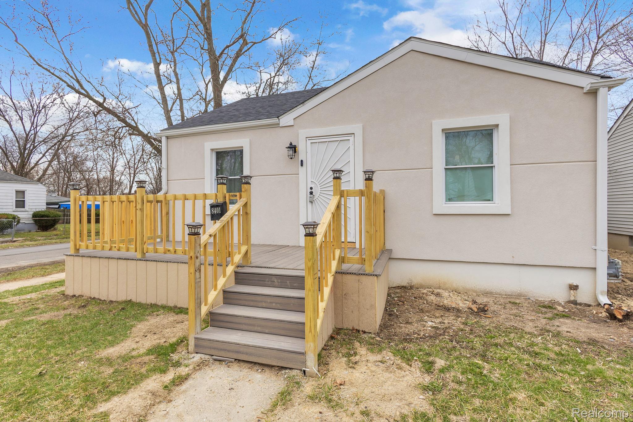8401 Fielding Street Detroit, MI 48228 - Photo 1 of 34 Bungalow-style house with stucco siding, a deck, and a shingled roof