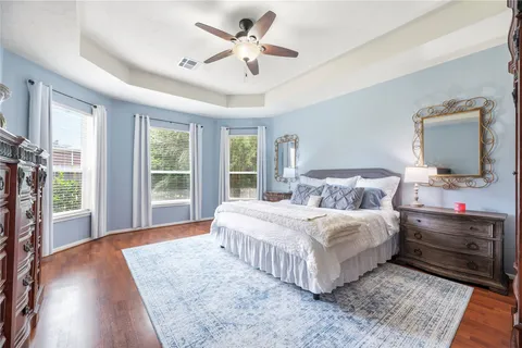 a bedroom with a large bed and a large window
