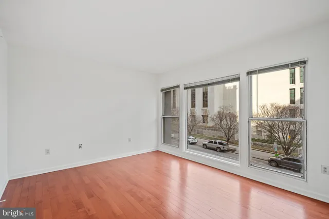 wooden floor in an empty room with a fireplace