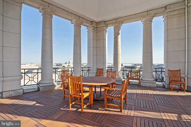 a view of a balcony with chairs and wooden floor