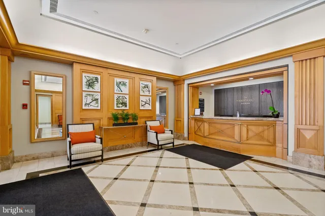 a living room with furniture and floor to ceiling windows