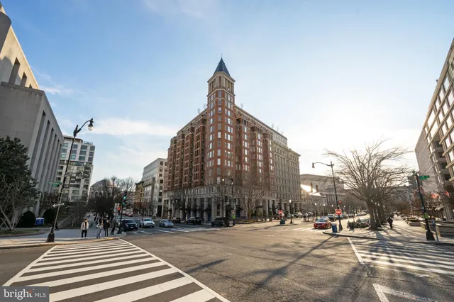 a view of a brick building with potted plants