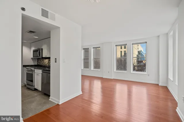 a view of a kitchen cabinets and wooden floor