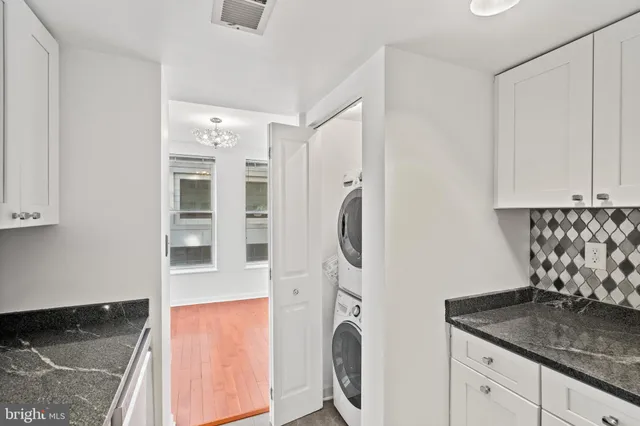 a kitchen with stainless steel appliances granite countertop a refrigerator and a stove