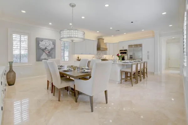 a kitchen with kitchen island granite countertop white cabinets and white appliances