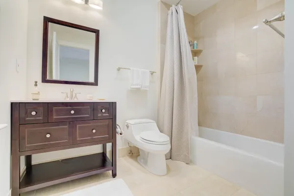 a white bath tub sitting next to a shower