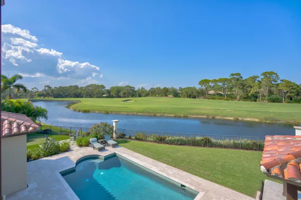a view of a house with swimming pool and sitting area