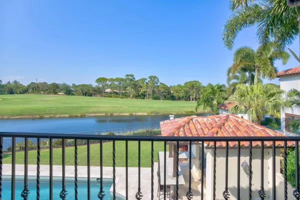 a view of a house with a swimming pool and sitting area