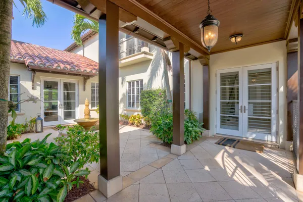 front view of a house with potted plants