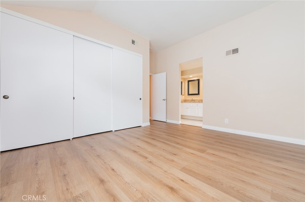 7 Tivoli Irvine, CA 92620 - Photo 20 of 29 a view of an empty room with wooden floor and a window