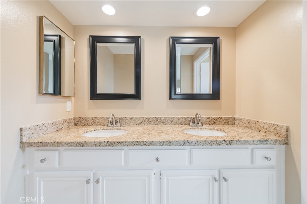 7 Tivoli Irvine, CA 92620 - Photo 23 of 29 a bathroom with double sink and a mirror