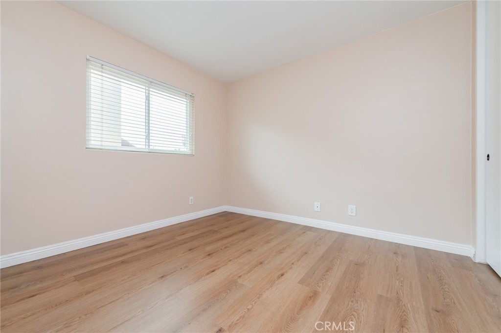 7 Tivoli Irvine, CA 92620 - Photo 24 of 29 an empty room with wooden floor and windows