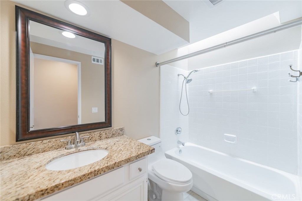 7 Tivoli Irvine, CA 92620 - Photo 26 of 29 a bathroom with a granite countertop sink a toilet and shower