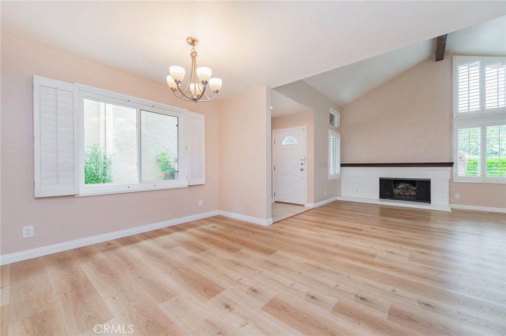 7 Tivoli Irvine, CA 92620 - Photo 7 of 29 an empty room with wooden floor fireplace and windows