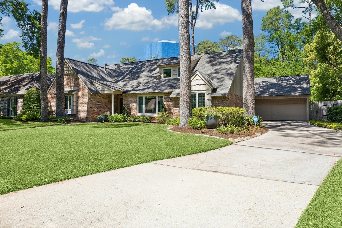 12206 Perthshire Road Houston, TX 77024 - Photo 30 of 30 Driveway leading to attached two-car garage.
