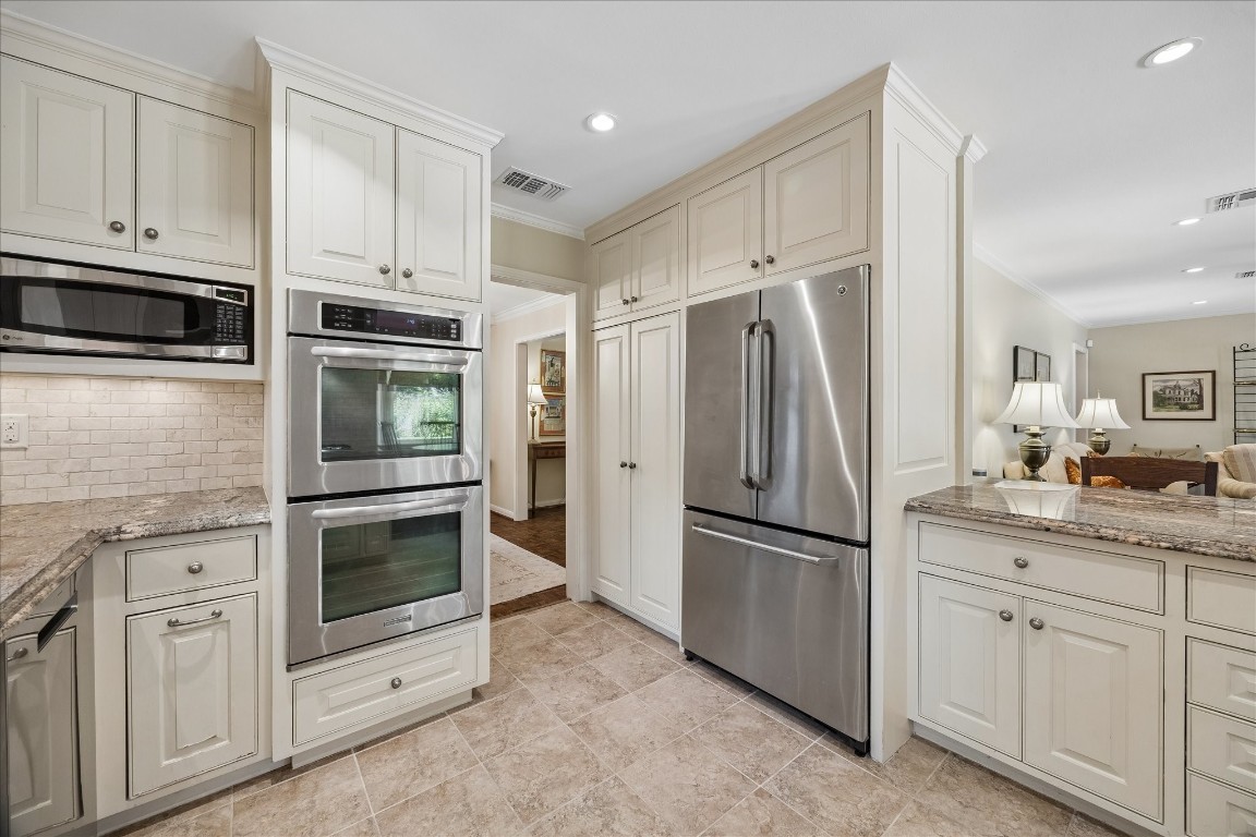 12206 Perthshire Road Houston, TX 77024 - Photo 10 of 30 Kitchen appliances include microwave, double ovens, and refrigerator/freezer.