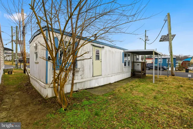 a backyard of a house with barbeque oven table and chairs