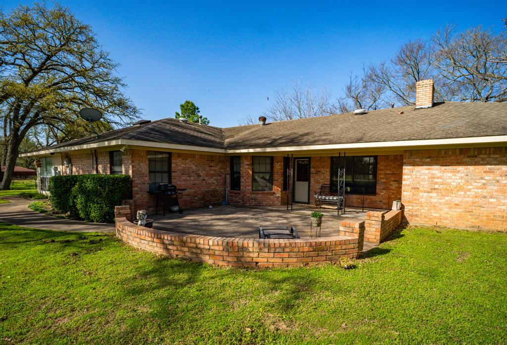 141 Lcr 405 Mexia, TX 76667 - Photo 13 of 40 a view of a house with a yard patio and fire pit