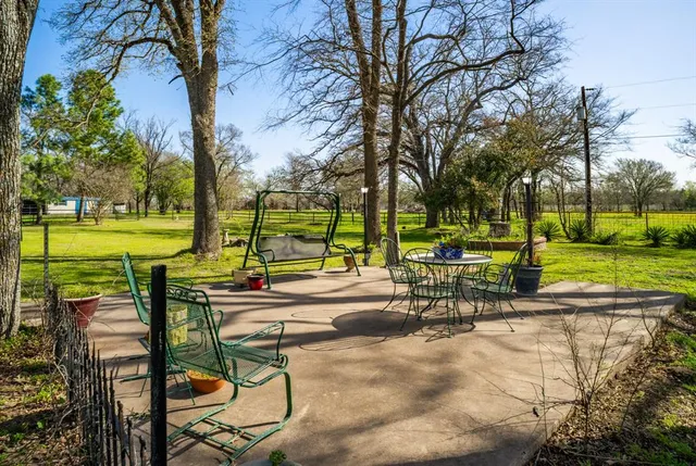 a view of a house with backyard porch and sitting area