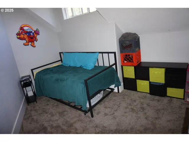 a bedroom with a bed and a dresser