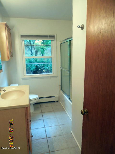 5 Interlaken Road Stockbridge, MA 01266 - Photo 14 of 16 a bathroom with a sink toilet and window