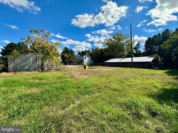 a view of a fountain in front of a house with a yard
