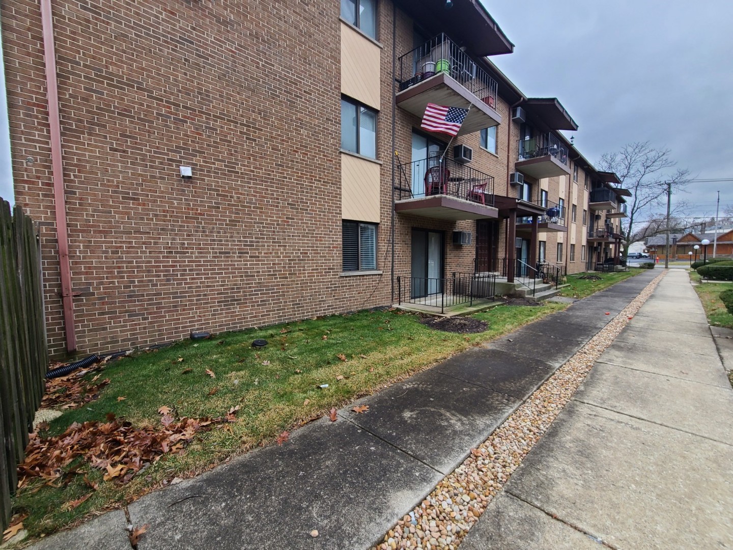 9117 South Roberts Road, Unit 8A Hickory Hills, IL 60457 - Photo 2 of 16 a front view of a house with garden
