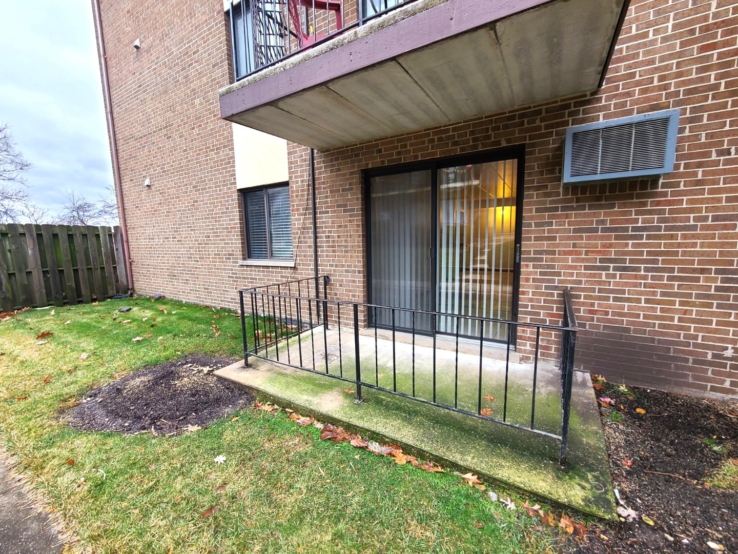 9117 South Roberts Road, Unit 8A Hickory Hills, IL 60457 - Photo 3 of 16 a view of a house with a small yard and wooden floor and fence
