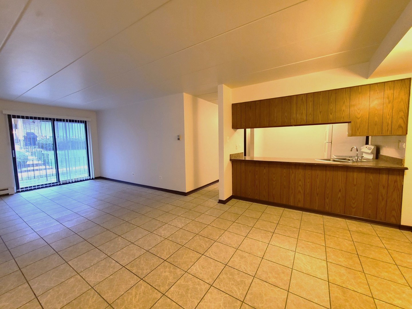 9117 South Roberts Road, Unit 8A Hickory Hills, IL 60457 - Photo 4 of 16 a view of an empty room with wooden floor and a window