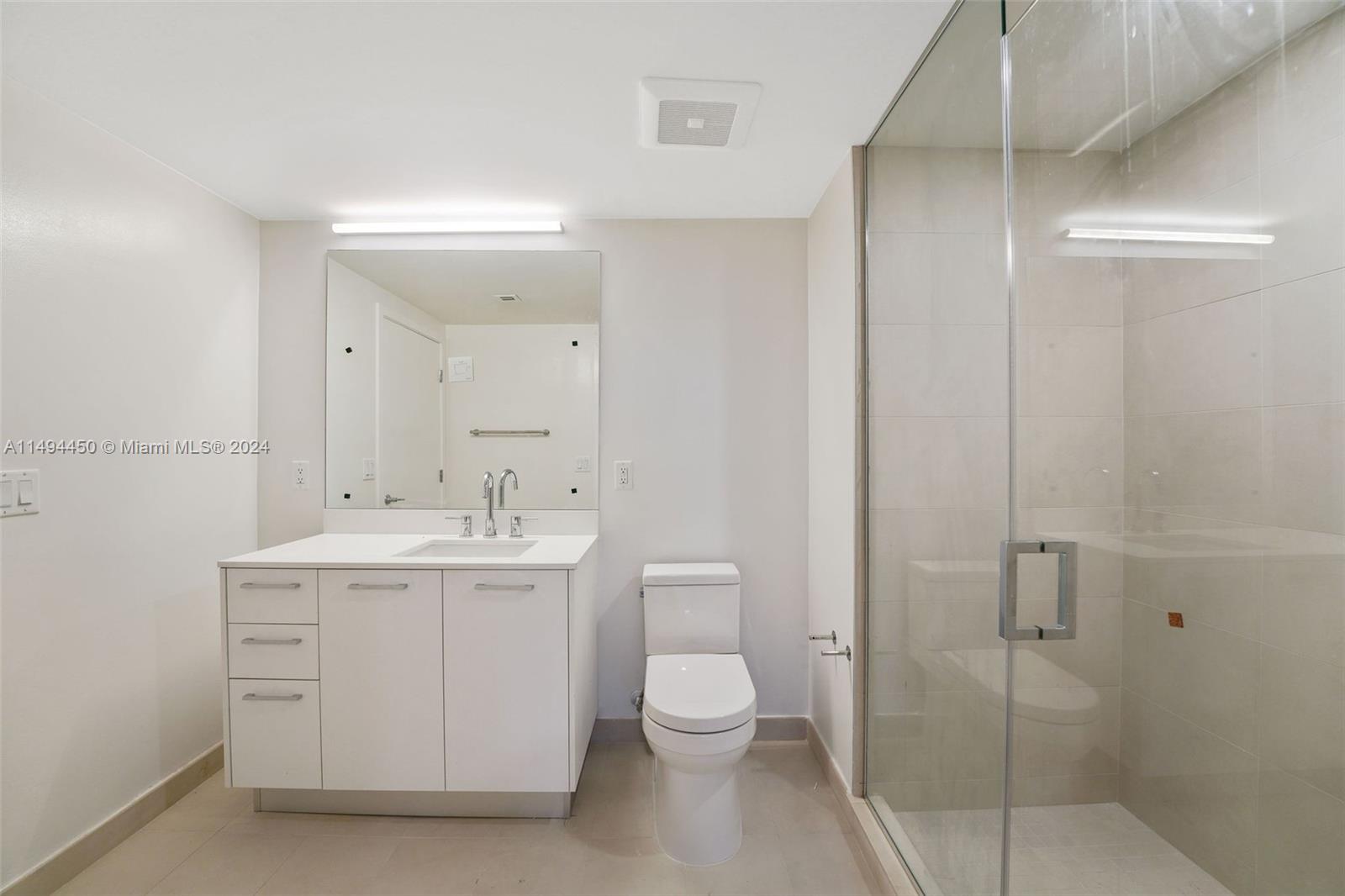 1500 Bay Road, Unit N0109 Miami Beach, FL 33139 - Photo 11 of 73 a bathroom with a toilet a sink and mirror