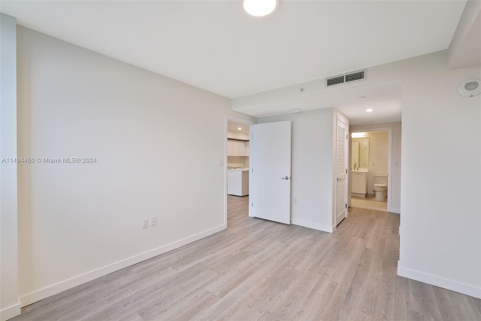 1500 Bay Road, Unit N0109 Miami Beach, FL 33139 - Photo 12 of 73 a view of an empty room with wooden floor and a window