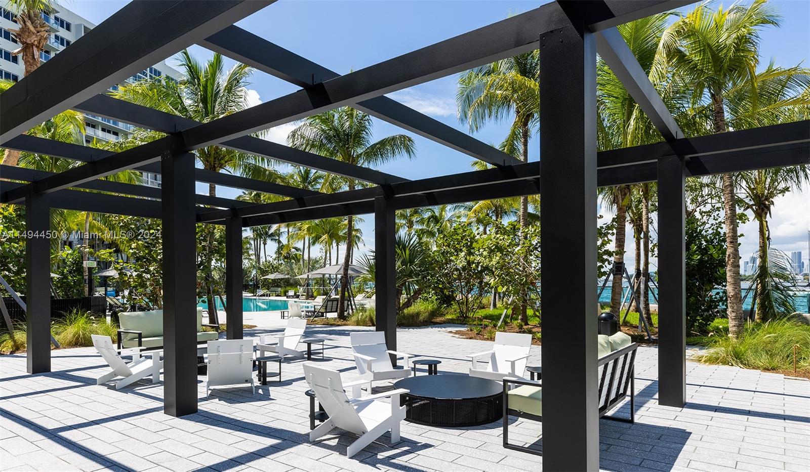 1500 Bay Road, Unit N0109 Miami Beach, FL 33139 - Photo 17 of 73 a living room with large windows and outdoor seating