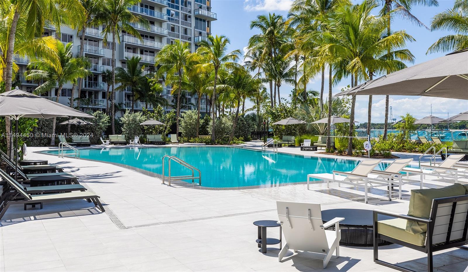 1500 Bay Road, Unit N0109 Miami Beach, FL 33139 - Photo 2 of 73 a view of a swimming pool with a patio and a yard