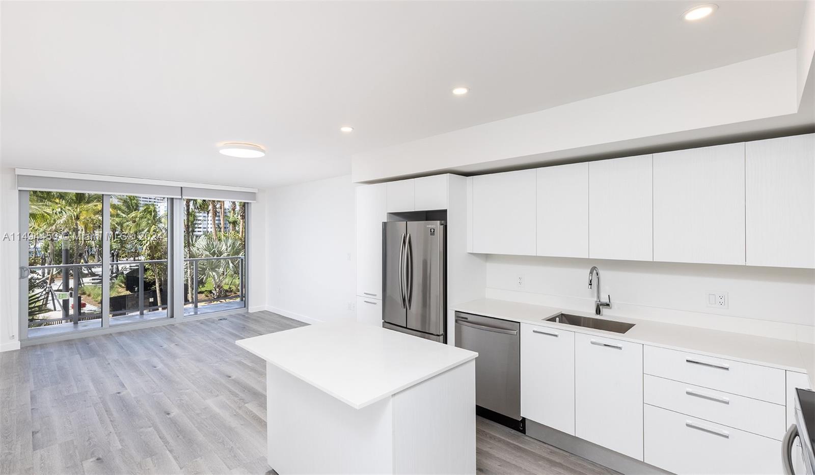 1500 Bay Road, Unit N0109 Miami Beach, FL 33139 - Photo 3 of 73 a kitchen with a sink a refrigerator and wooden floor