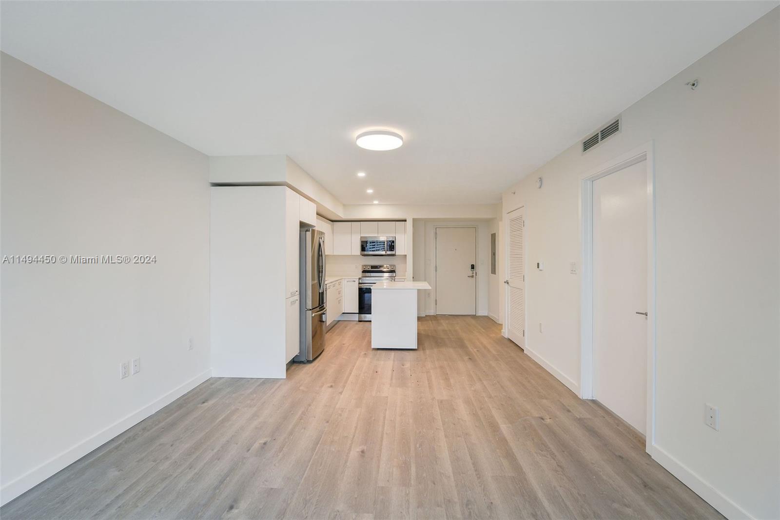 1500 Bay Road, Unit N0109 Miami Beach, FL 33139 - Photo 9 of 73 a view of empty room with wooden floor