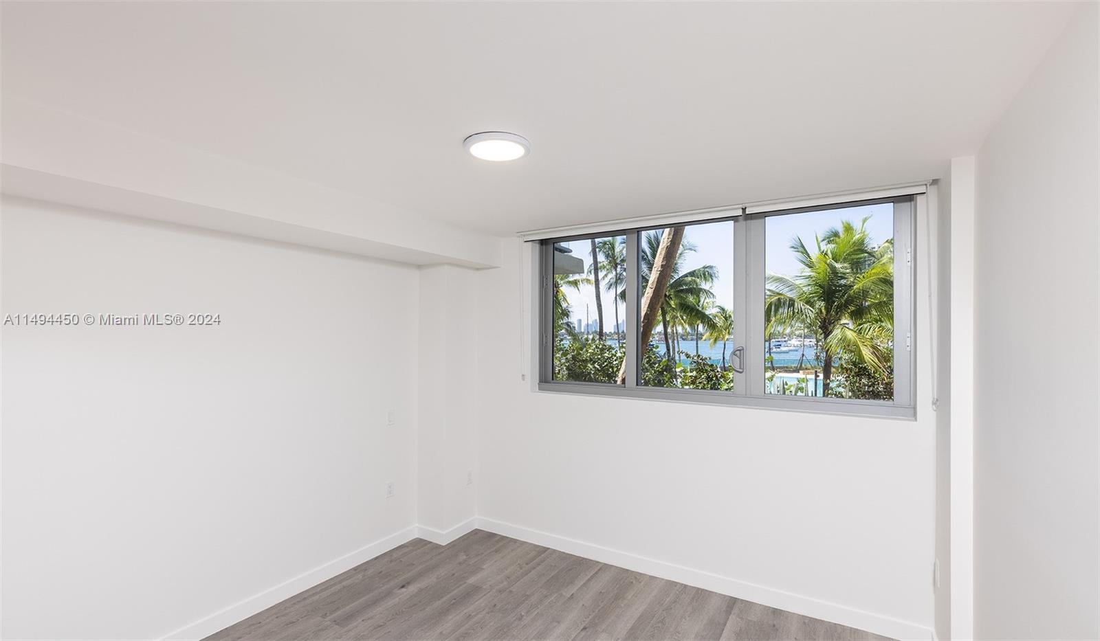 1500 Bay Road, Unit N0109 Miami Beach, FL 33139 - Photo 10 of 73 a view of a room that has a window and wooden floor