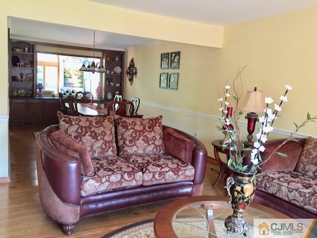 87 Harding Avenue Edison, NJ 08820 - Photo 2 of 25 a living room with furniture and a large mirror