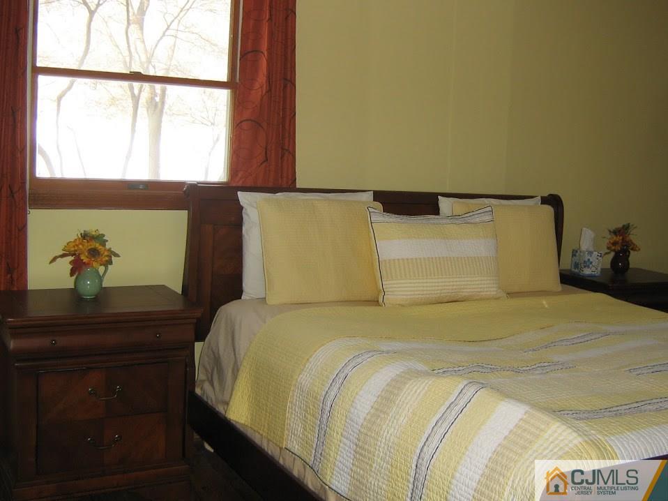 87 Harding Avenue Edison, NJ 08820 - Photo 12 of 25 a bedroom with a bed and a window