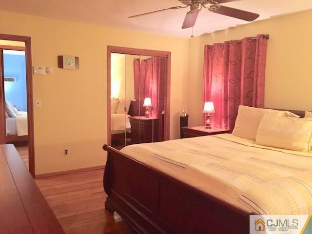 87 Harding Avenue Edison, NJ 08820 - Photo 14 of 25 a bedroom with a bed and a chandelier