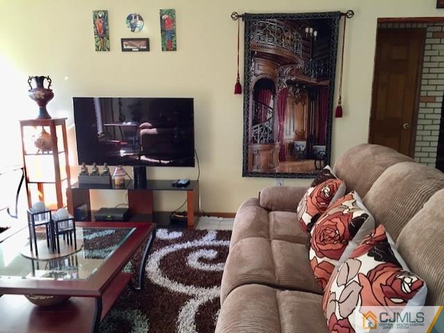 87 Harding Avenue Edison, NJ 08820 - Photo 21 of 25 a living room with furniture and painting on the wall