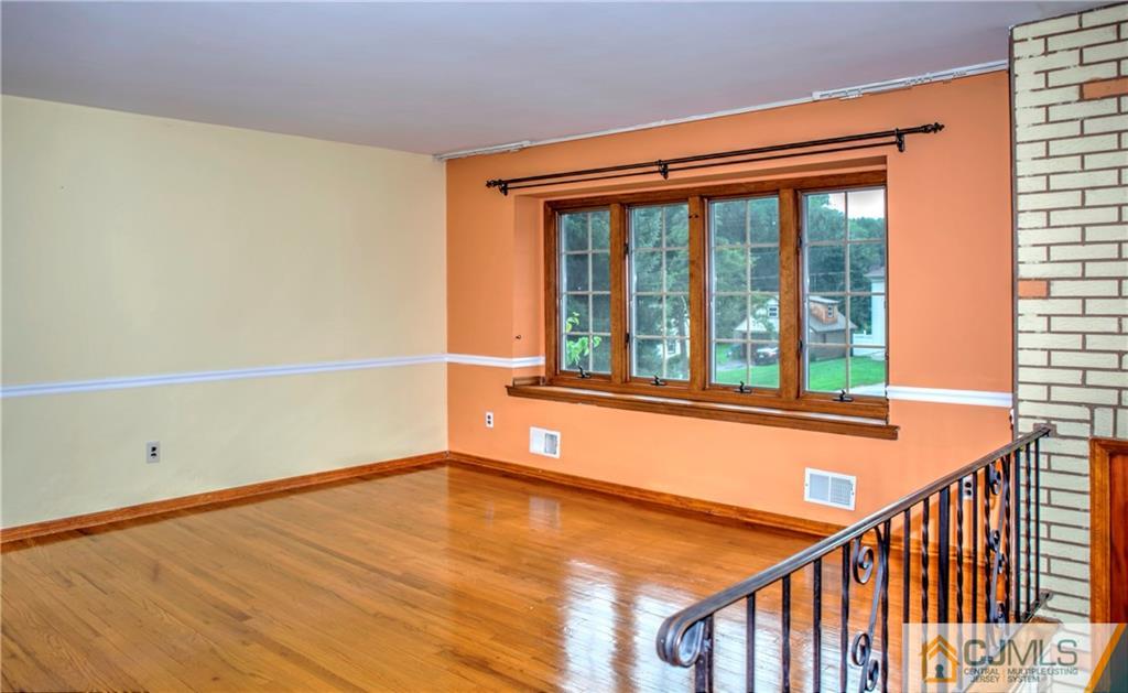 87 Harding Avenue Edison, NJ 08820 - Photo 4 of 25 a view of an empty room with wooden floor and a window