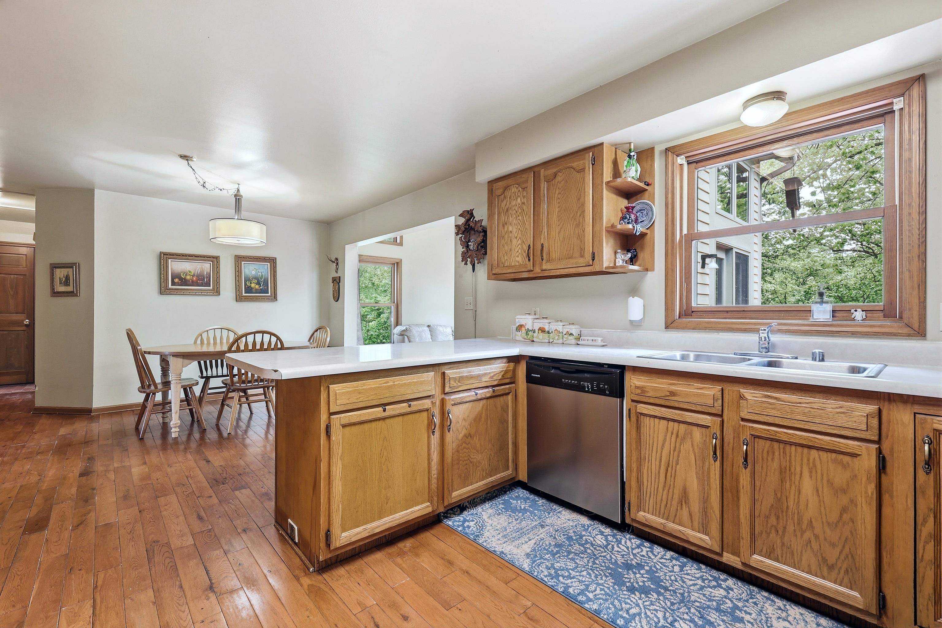 13 Signal Point Lane Galena, IL 61036 - Photo 17 of 47 a kitchen with stainless steel appliances granite countertop wooden floors and wooden cabinets