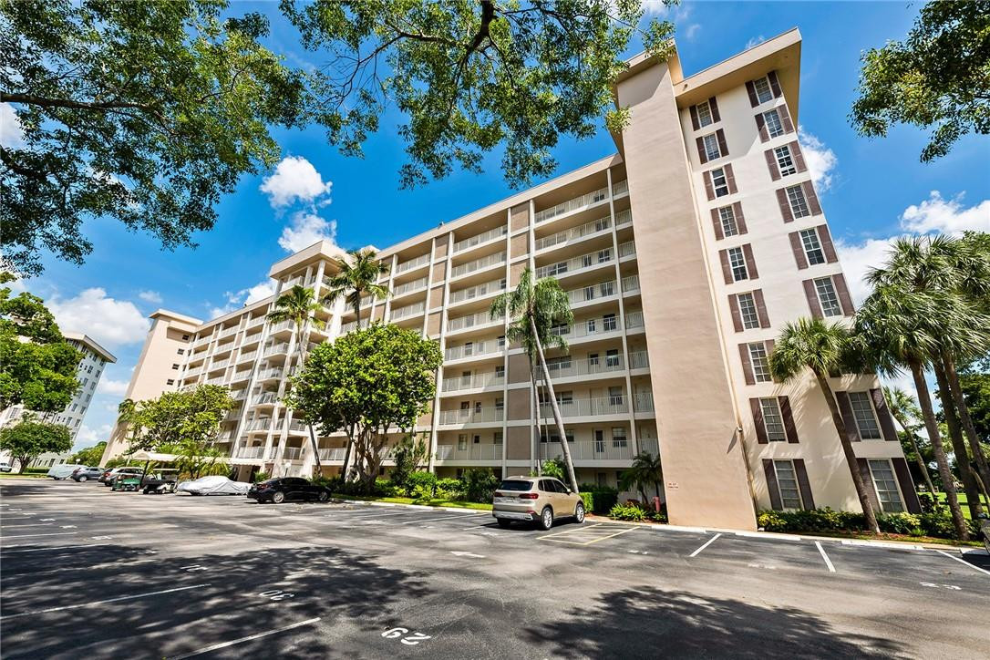 2661 South Course Drive, Unit 209 Pompano Beach, FL 33069 - Photo 1 of 21 a front view of a building and a street
