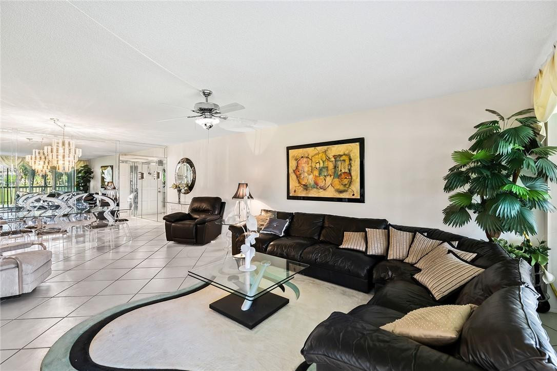 2661 South Course Drive, Unit 209 Pompano Beach, FL 33069 - Photo 11 of 21 a living room with furniture or couch and a potted plant